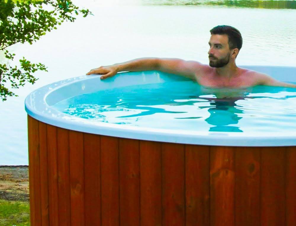 Man taking a dip in an at-home ice bath